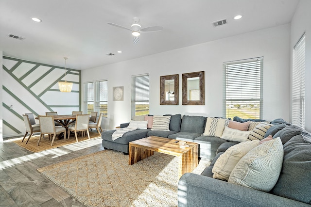 living room featuring a wealth of natural light, hardwood / wood-style floors, and ceiling fan