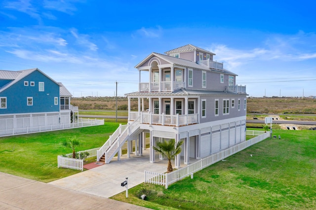 rear view of property featuring a balcony and a lawn