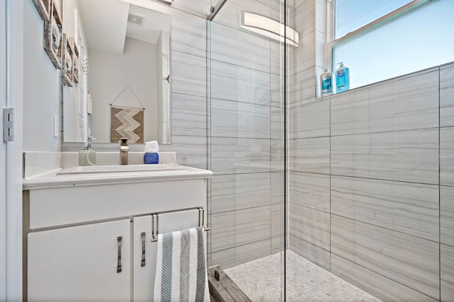 bathroom featuring large vanity and an enclosed shower