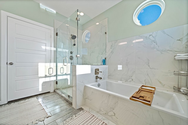 bathroom featuring tile flooring, independent shower and bath, and tile walls