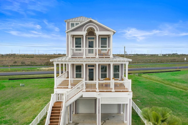 rear view of property featuring a garage and a yard