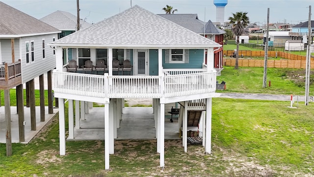 back of house with a wooden deck and a yard