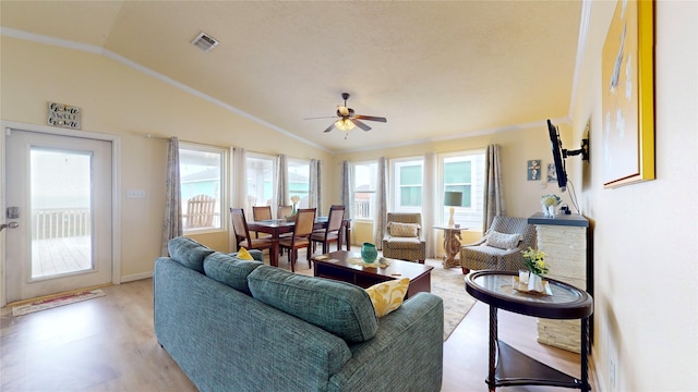 living room with lofted ceiling, ceiling fan, light wood-type flooring, and crown molding