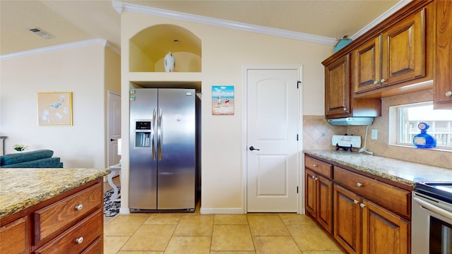 kitchen with light stone countertops, tasteful backsplash, crown molding, lofted ceiling, and stainless steel refrigerator with ice dispenser