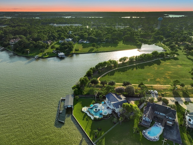 aerial view at dusk featuring a water view