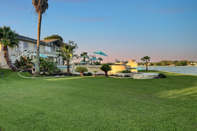 yard at dusk with a water view