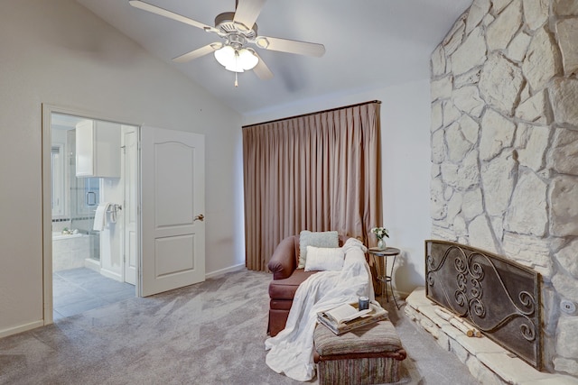 sitting room featuring light carpet, a stone fireplace, lofted ceiling, and ceiling fan