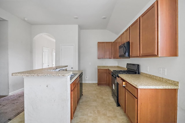 kitchen with an island with sink, sink, light tile floors, and black appliances