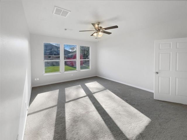 carpeted spare room featuring ceiling fan