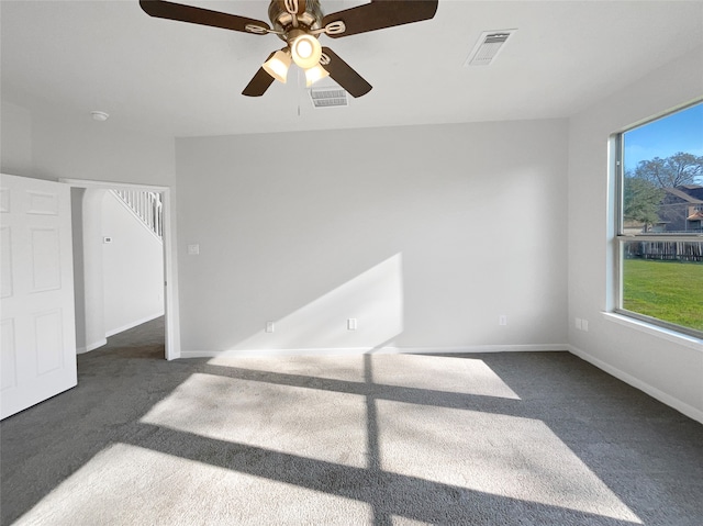 carpeted empty room featuring a healthy amount of sunlight and ceiling fan