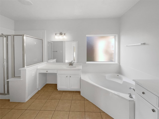 bathroom featuring tile flooring, shower with separate bathtub, and vanity