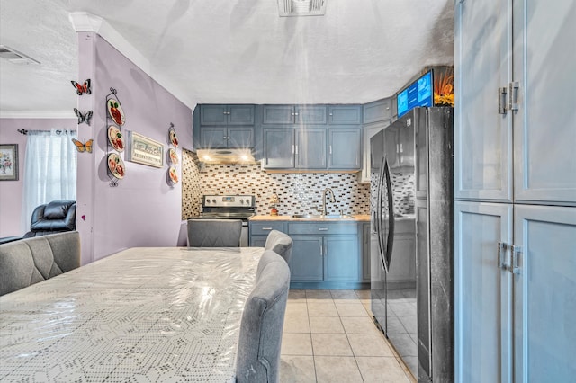 kitchen featuring stainless steel appliances, light tile flooring, a textured ceiling, crown molding, and sink