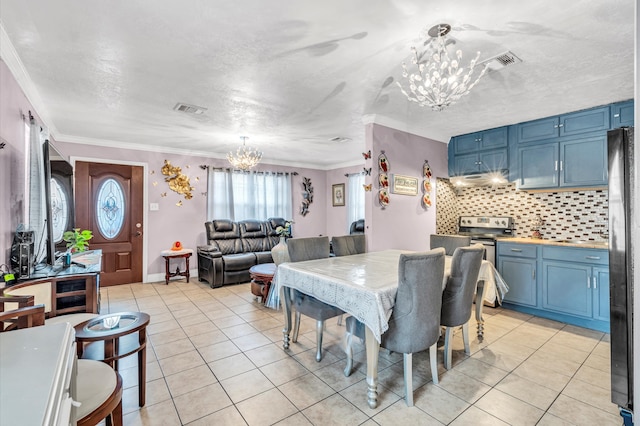 dining room with light tile floors, a notable chandelier, and ornamental molding