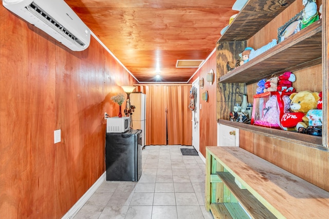 interior space with wooden ceiling, wooden walls, a wall mounted air conditioner, and light tile flooring