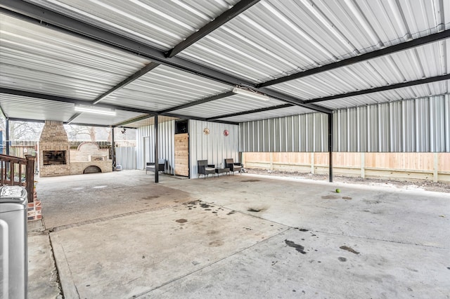 garage featuring a large fireplace and washer / dryer