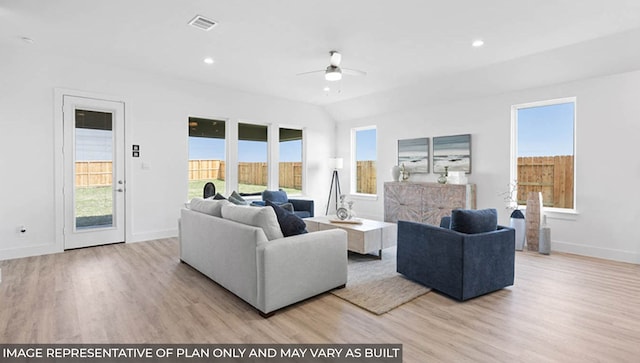 living room with vaulted ceiling, light hardwood / wood-style flooring, and ceiling fan