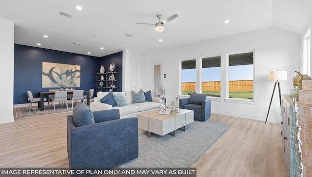 living room featuring ceiling fan and light hardwood / wood-style floors