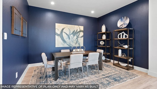 dining space with hardwood / wood-style flooring