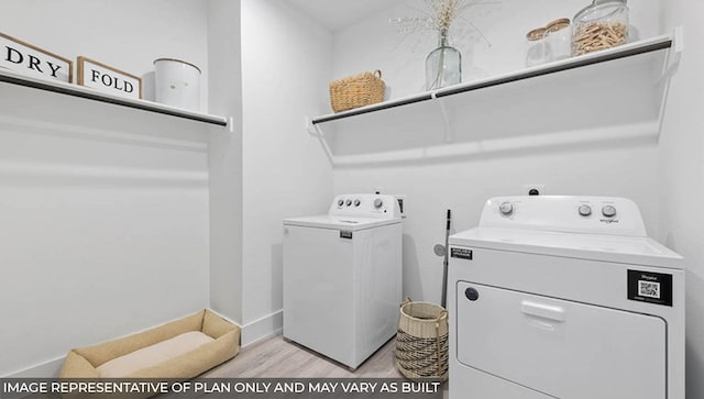 laundry room featuring washing machine and dryer and light hardwood / wood-style floors