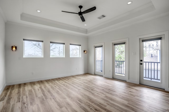 unfurnished room featuring ceiling fan, a raised ceiling, and light hardwood / wood-style floors