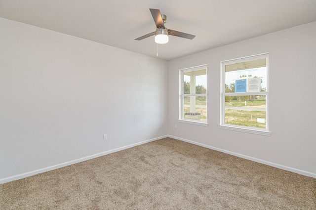 carpeted spare room with ceiling fan