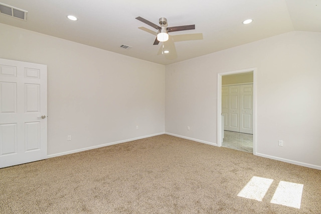 unfurnished room featuring ceiling fan, lofted ceiling, and carpet flooring