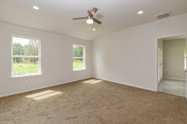 carpeted spare room with ceiling fan and a healthy amount of sunlight