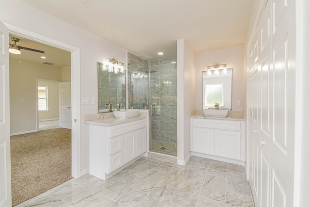 bathroom featuring a healthy amount of sunlight, ceiling fan, an enclosed shower, and vanity