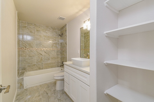 full bathroom featuring vanity, toilet, and tiled shower / bath