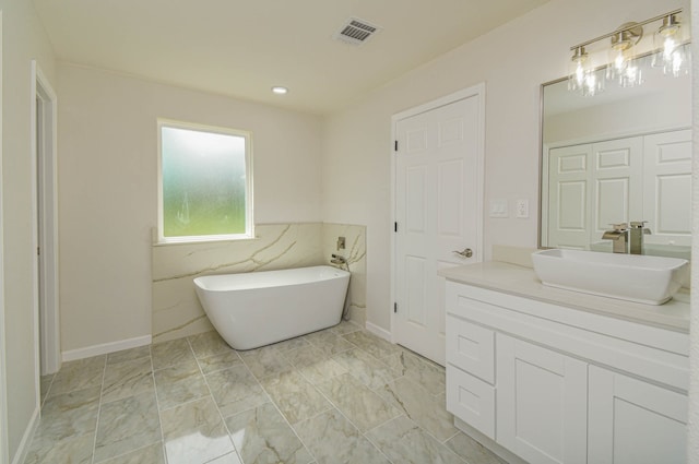 bathroom with tile walls, a tub, and vanity