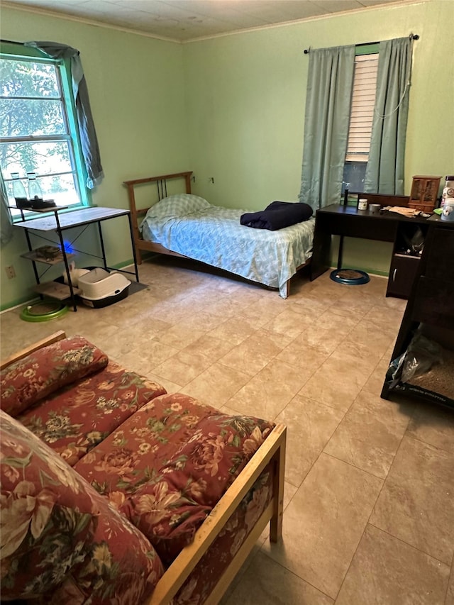 bedroom with crown molding and light tile patterned floors