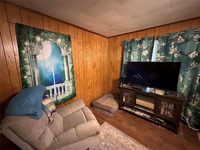 living room featuring hardwood / wood-style flooring and wood walls