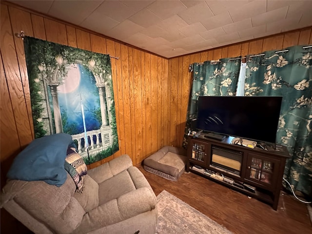 living room featuring wood-type flooring and wooden walls