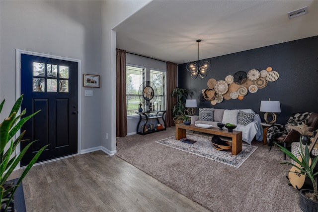 foyer featuring hardwood / wood-style floors and a chandelier