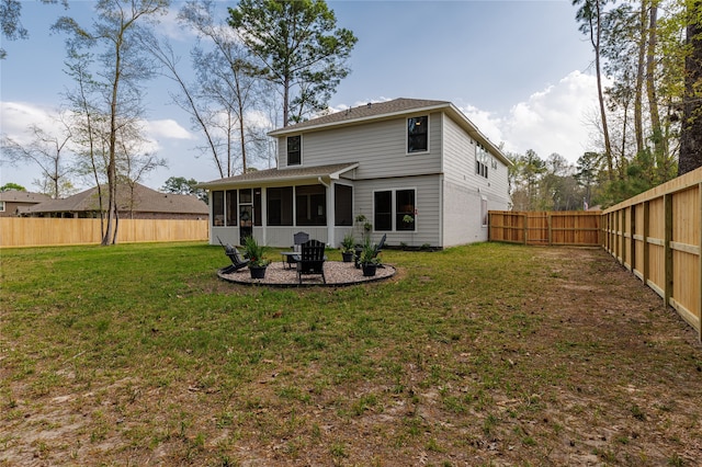 rear view of property featuring a sunroom and a yard