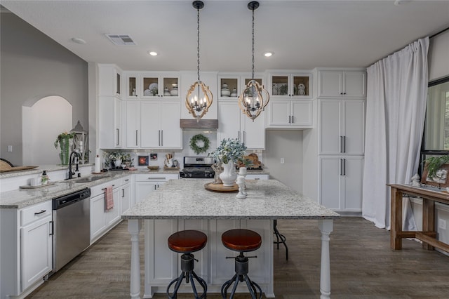 kitchen featuring light stone countertops, sink, white cabinets, and appliances with stainless steel finishes