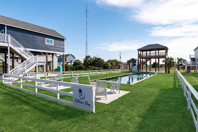 exterior space featuring a swimming pool, a lawn, and a gazebo