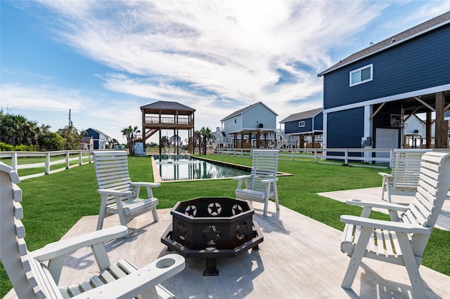 view of patio / terrace featuring a water view and a fire pit