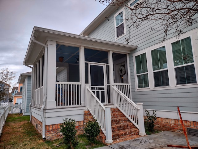 view of front facade with a sunroom and a patio