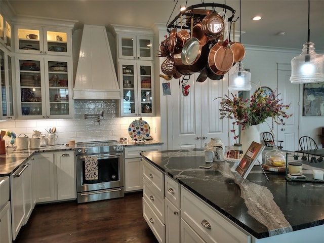 kitchen featuring appliances with stainless steel finishes, white cabinets, hanging light fixtures, dark hardwood / wood-style floors, and custom range hood