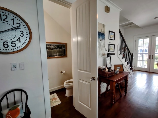 interior space with hardwood / wood-style floors, french doors, and toilet