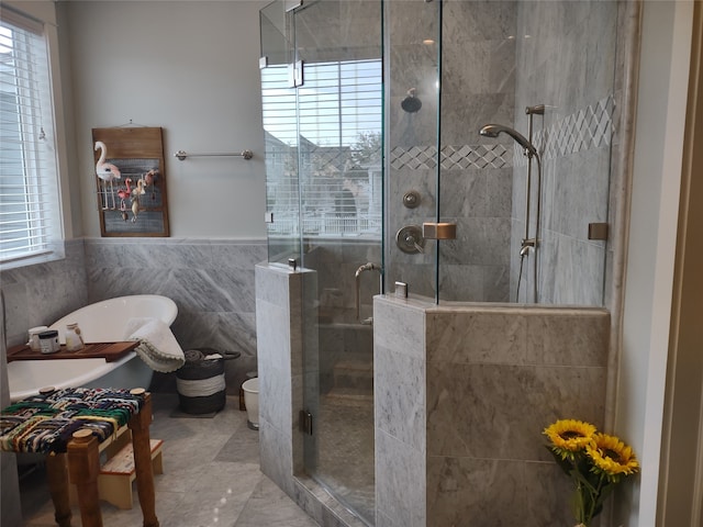 bathroom featuring toilet, tile flooring, tile walls, and plus walk in shower