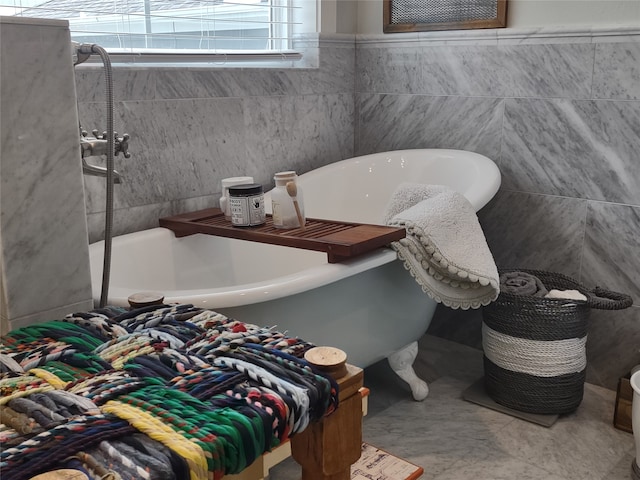 bathroom featuring a bath, tile walls, and tile floors