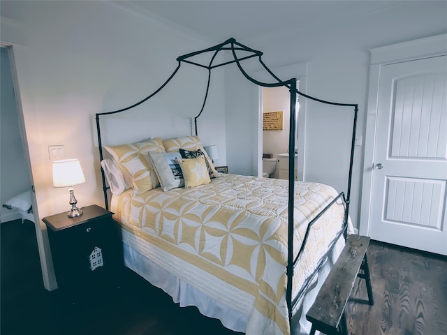 bedroom with dark hardwood / wood-style flooring