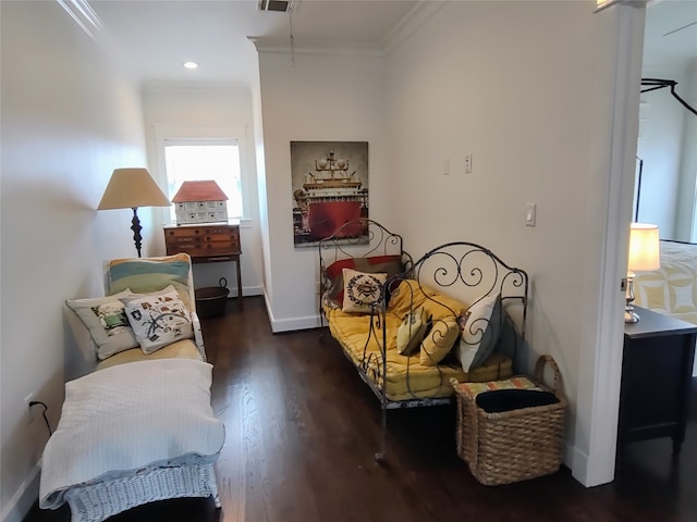 sitting room with crown molding and dark wood-type flooring