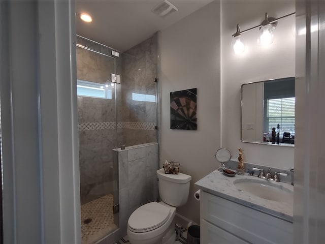 bathroom with walk in shower, vanity, and toilet