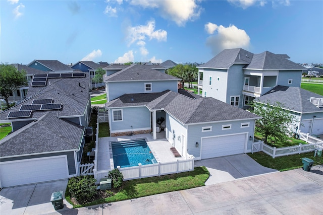 exterior space featuring a fenced in pool and a balcony