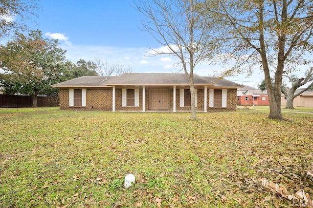 rear view of house featuring a yard