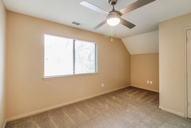 additional living space with ceiling fan, light carpet, and vaulted ceiling