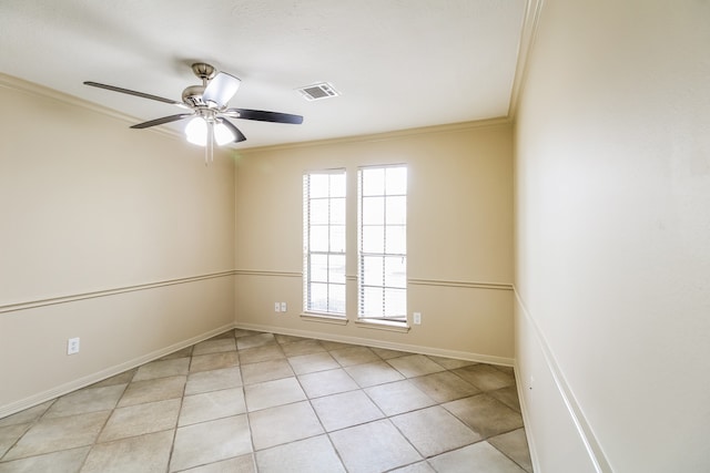 tiled spare room with ceiling fan and crown molding